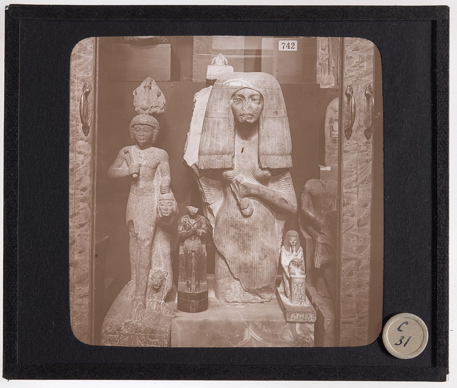 Historical museum case with Egyptian sculptures