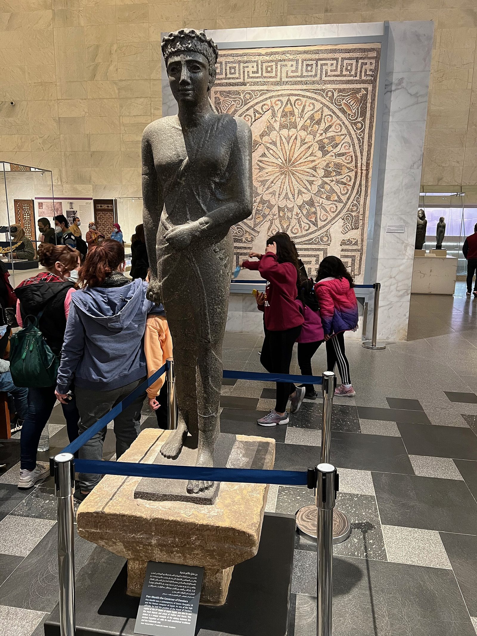 Fragmentary museum object displayed with modern support and completed areas